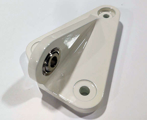 A white piece of metal with a screw on it.